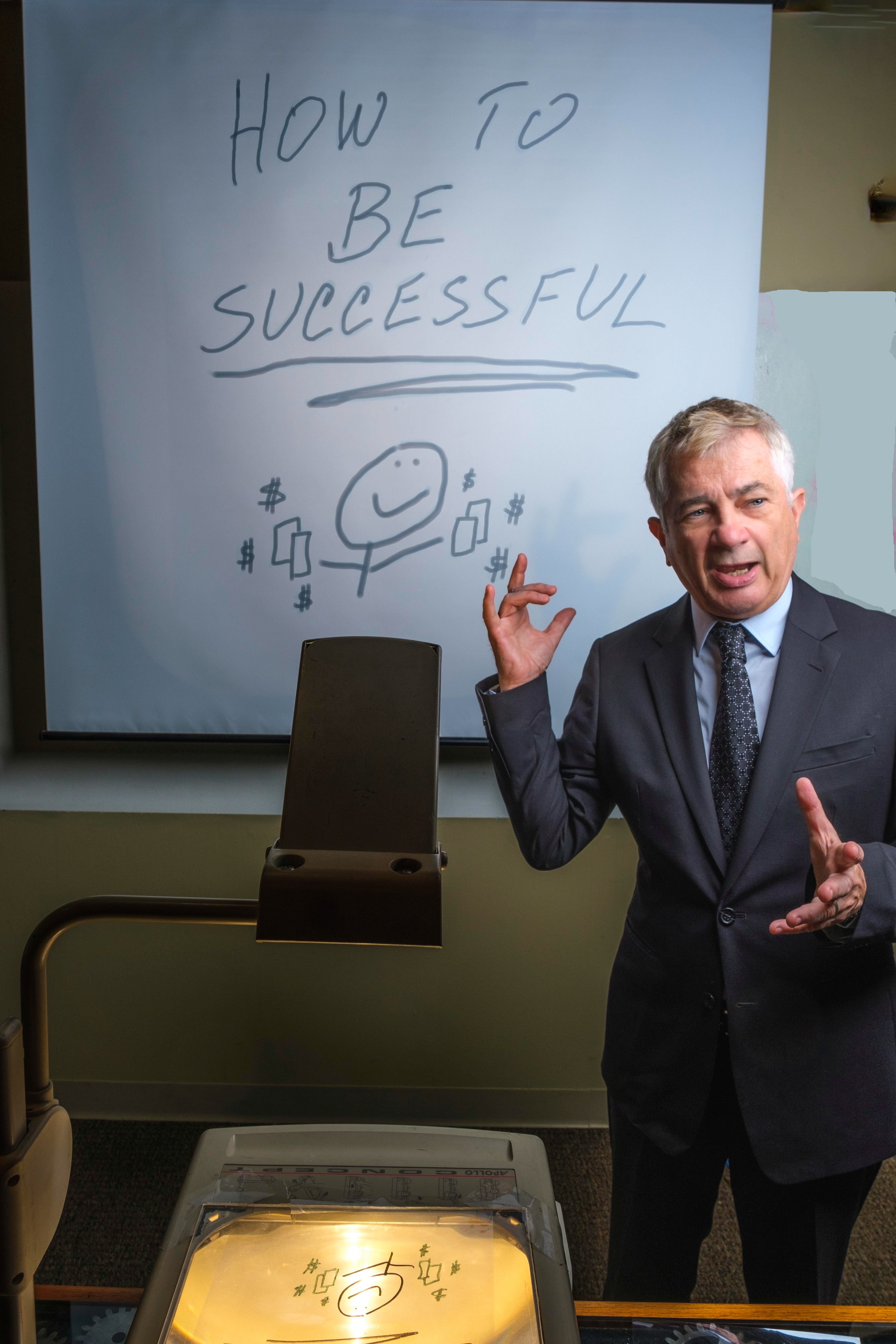 Corporate Comedian Brian Longwell delivering presentation with overhead projector